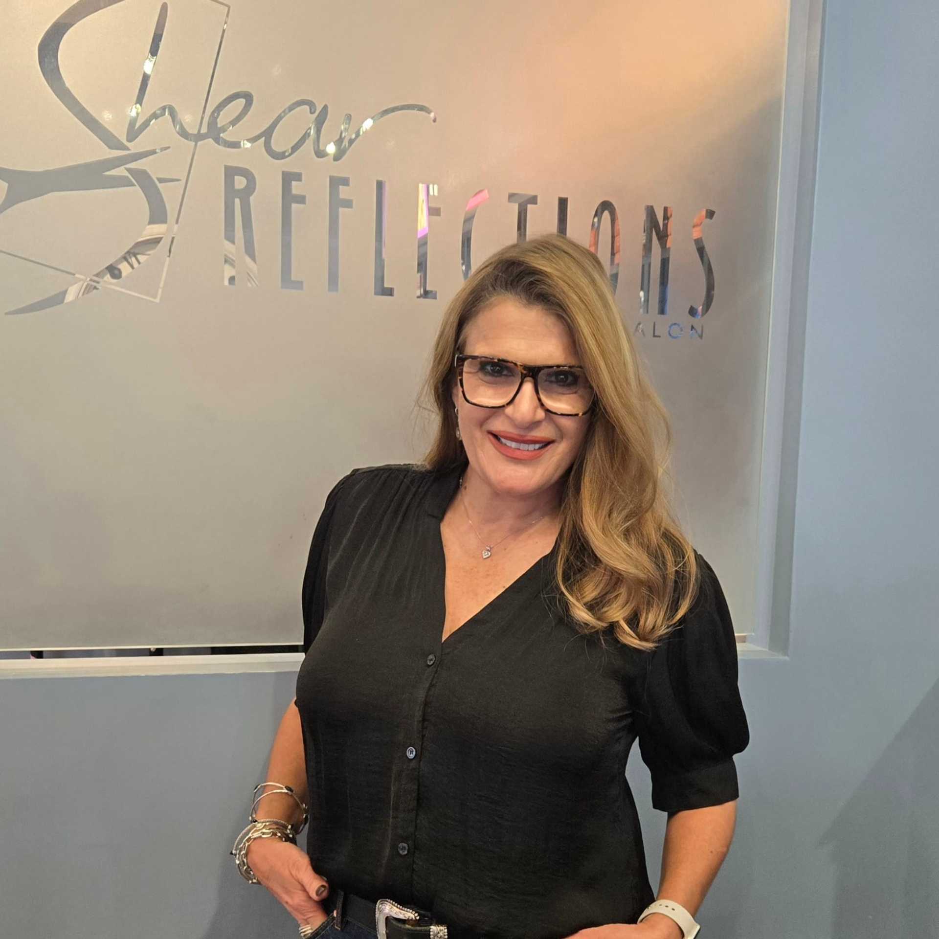 Portrait of Sandy, a professional stylist at Shear Reflections Hair Salon, showcasing their expertise and style.