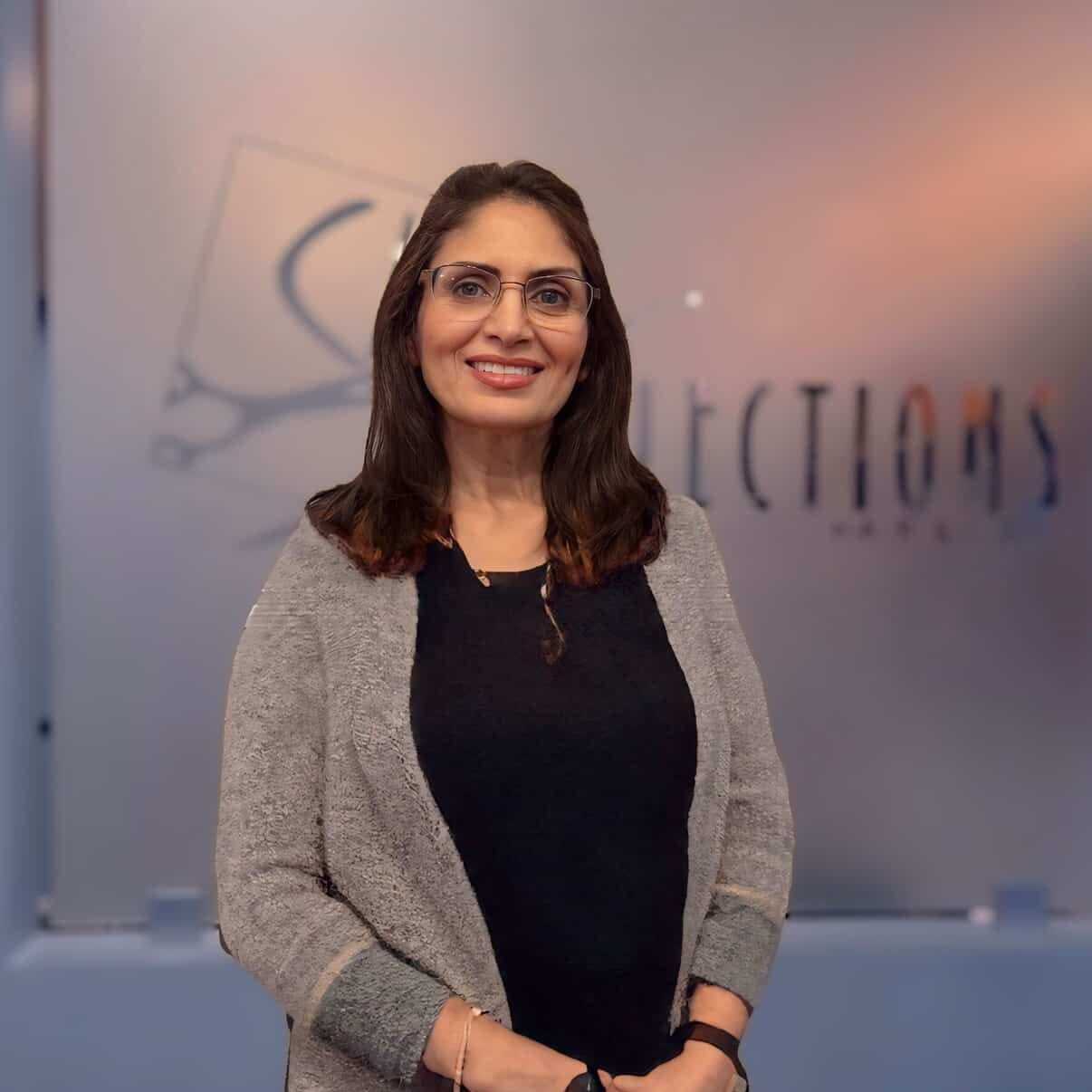 Portrait of Pinky, a professional stylist at Shear Reflections Hair Salon, showcasing their expertise and style.