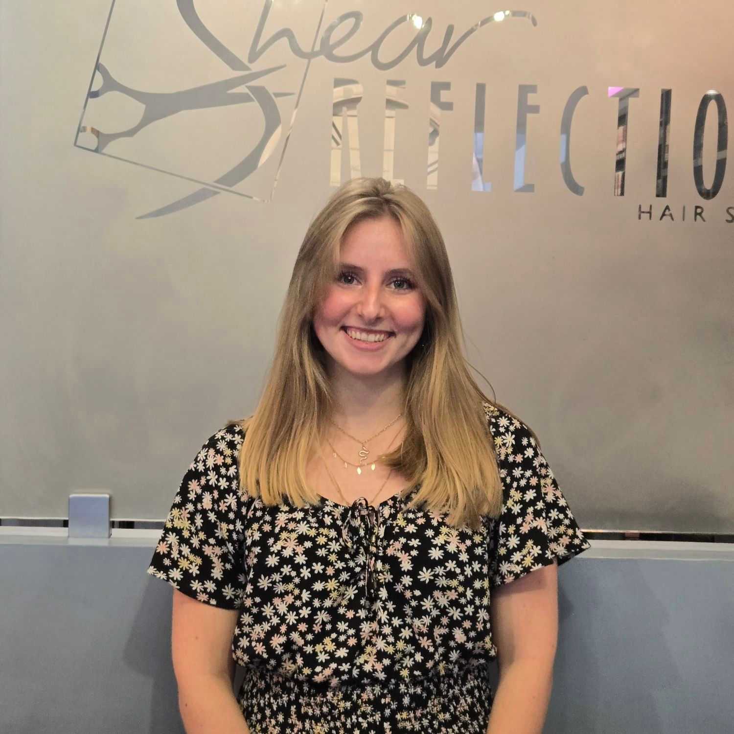 Portrait of Nellie, a professional stylist at Shear Reflections Hair Salon, showcasing their expertise and style.