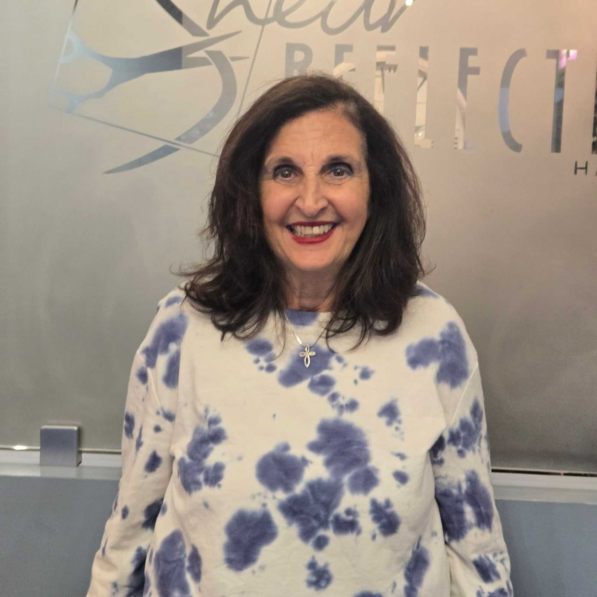 Portrait of Joni, a professional stylist at Shear Reflections Hair Salon, showcasing their expertise and style.