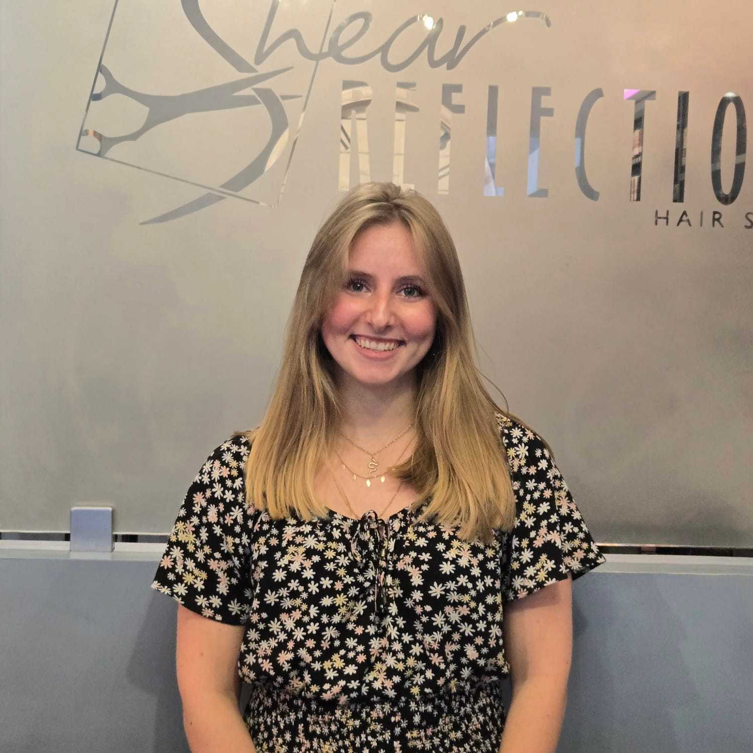 Portrait of Nellie, a professional stylist at Shear Reflections Hair Salon, showcasing their expertise and style.