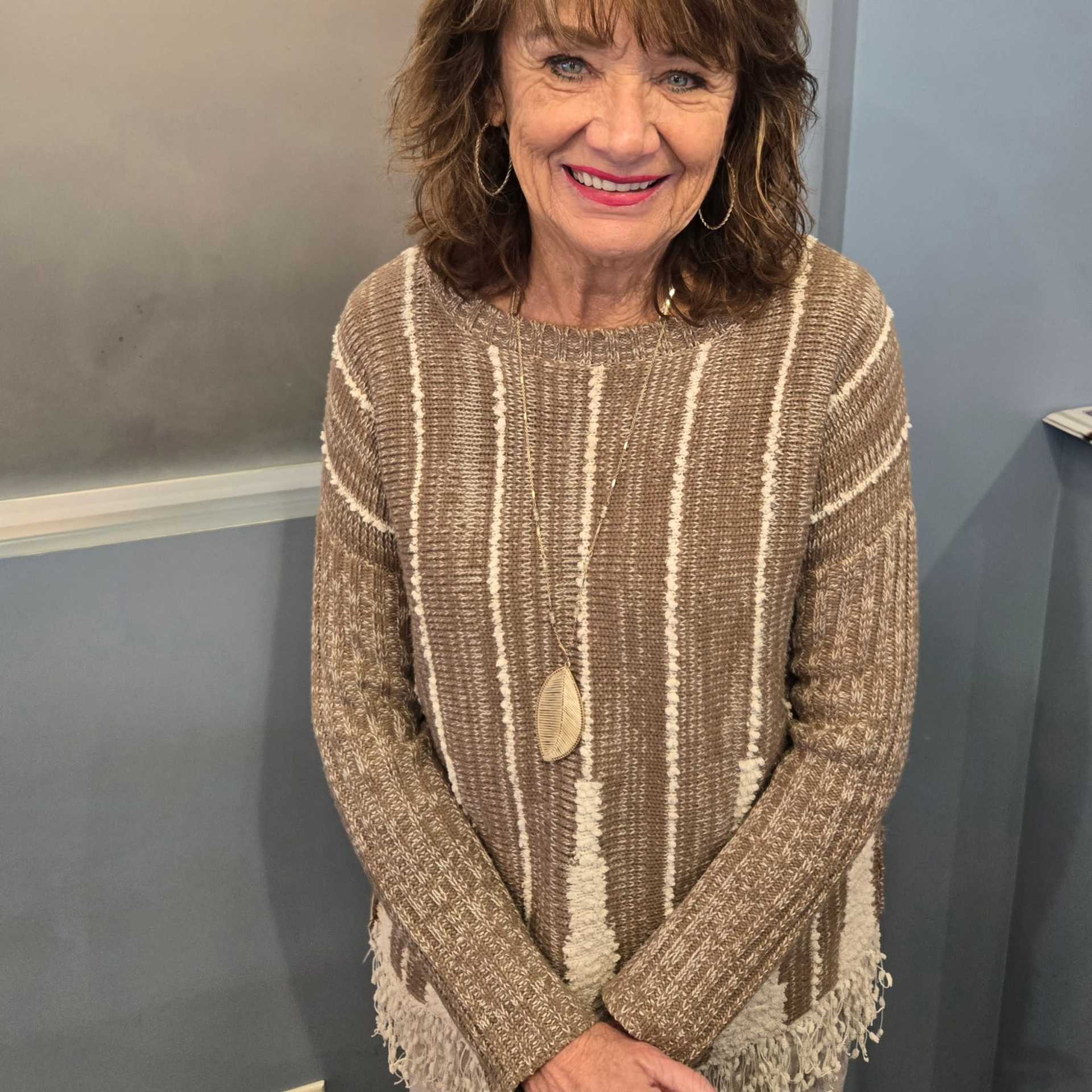 Portrait of Carol, a professional stylist at Shear Reflections Hair Salon, showcasing their expertise and style.