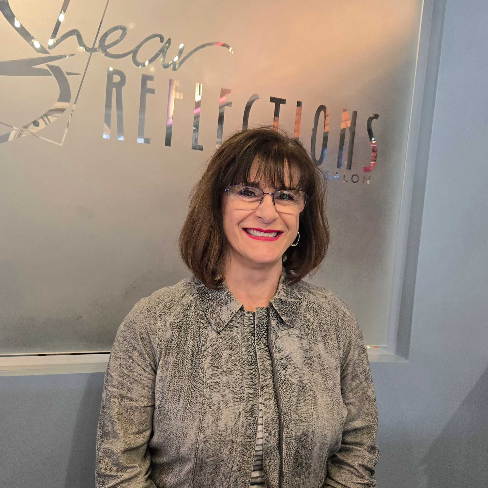 Portrait of Sue M., a professional stylist at Shear Reflections Hair Salon, showcasing their expertise and style.