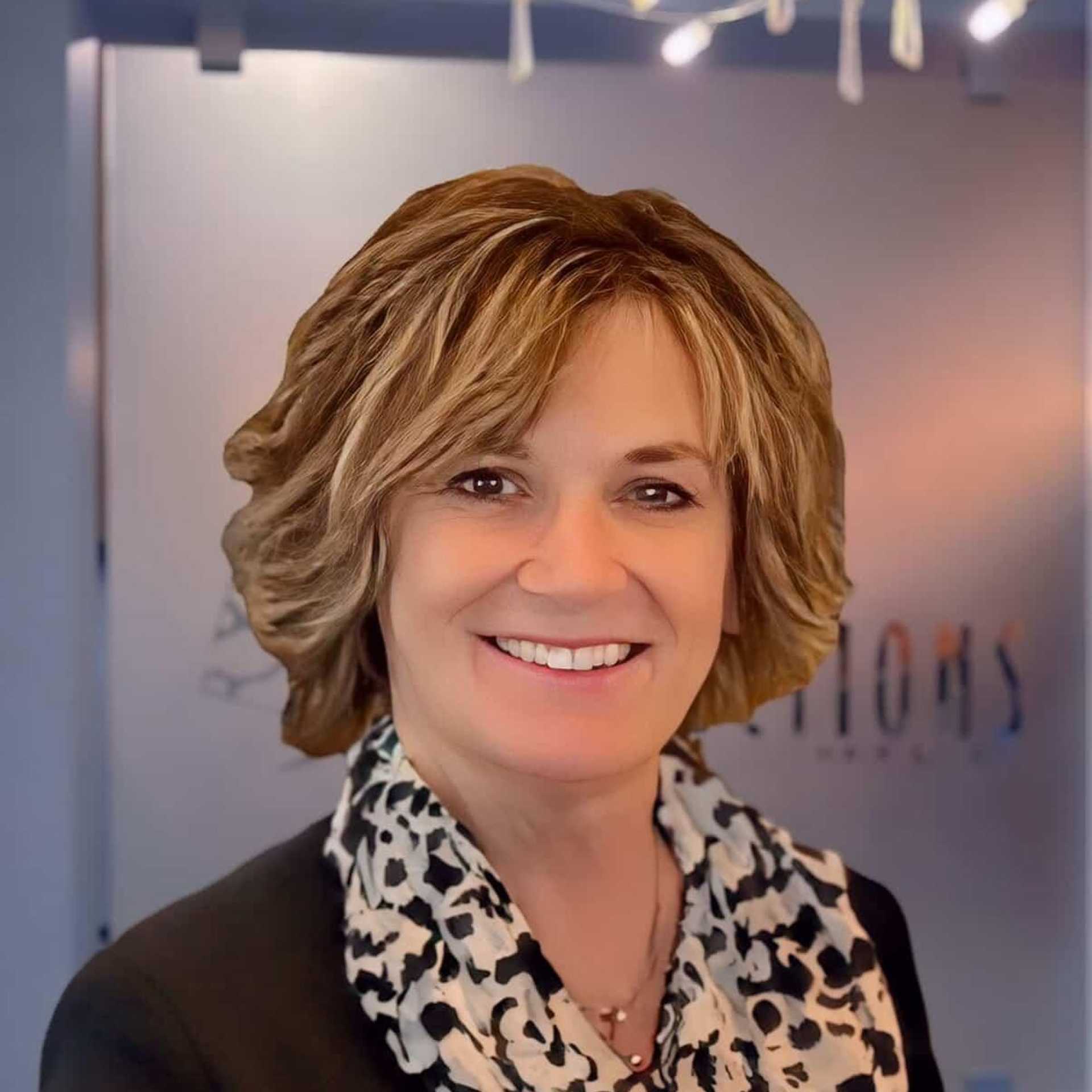 Portrait of Elaine, a professional stylist at Shear Reflections Hair Salon, showcasing their expertise and style.