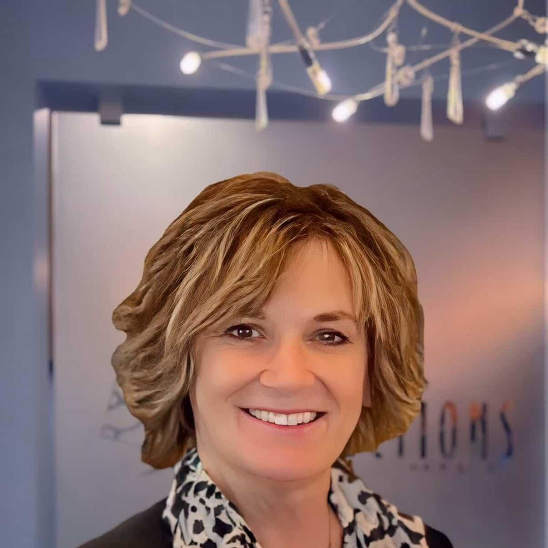 Portrait of Elaine, a professional stylist at Shear Reflections Hair Salon, showcasing their expertise and style.