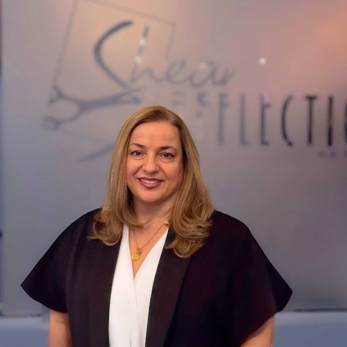 Portrait of Mary, a professional stylist at Shear Reflections Hair Salon, showcasing their expertise and style.