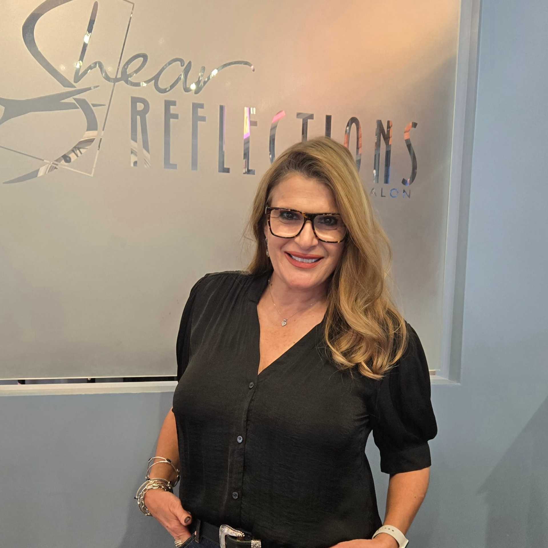 Portrait of Sandy, a professional stylist at Shear Reflections Hair Salon, showcasing their expertise and style.
