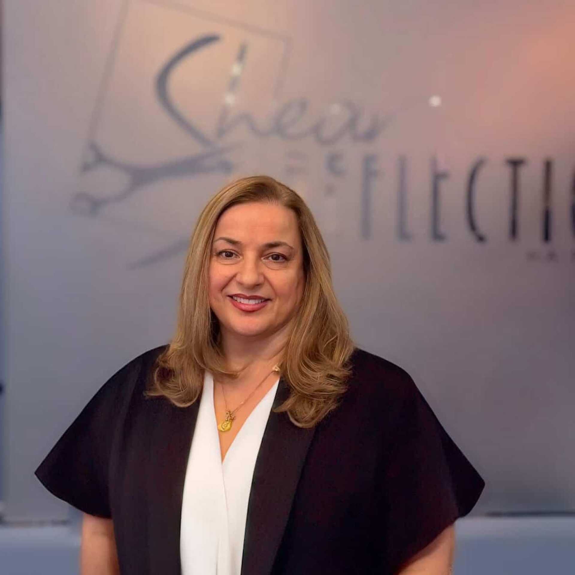 Portrait of Mary, a professional stylist at Shear Reflections Hair Salon, showcasing their expertise and style.