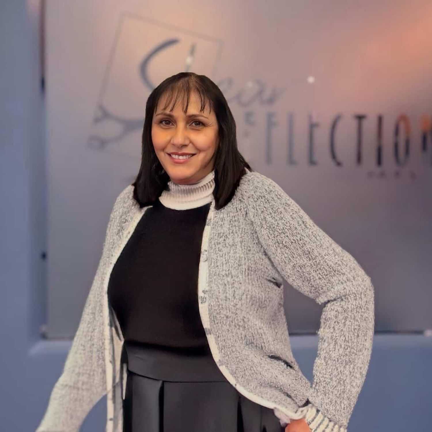 Portrait of Vivian, a professional stylist at Shear Reflections Hair Salon, showcasing their expertise and style.