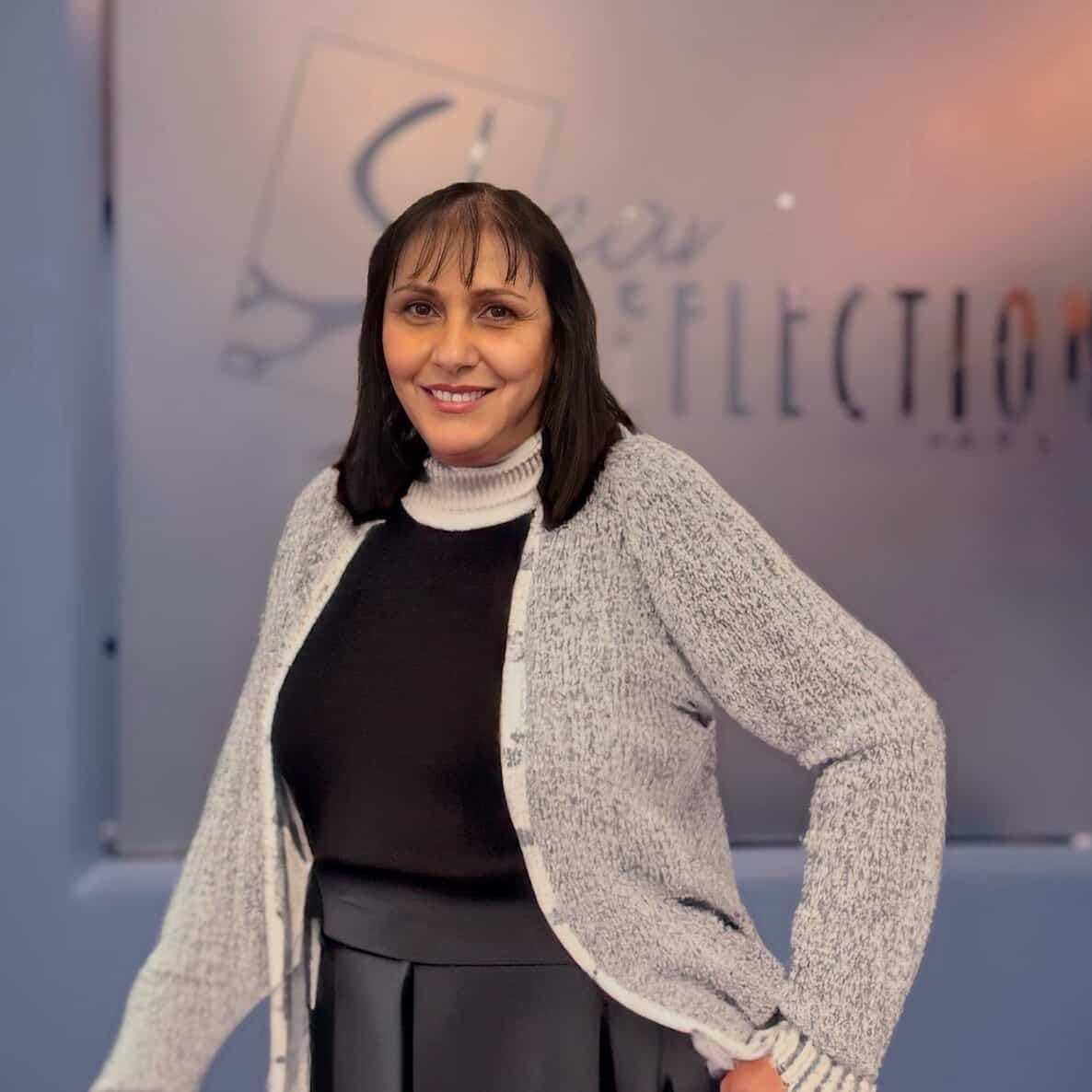 Portrait of Vivian, a professional stylist at Shear Reflections Hair Salon, showcasing their expertise and style.