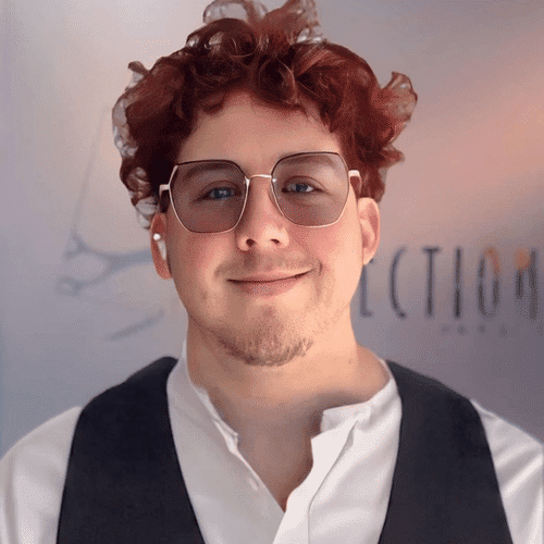 Portrait of Rowan, a professional stylist at Shear Reflections Hair Salon, showcasing their expertise and style.
