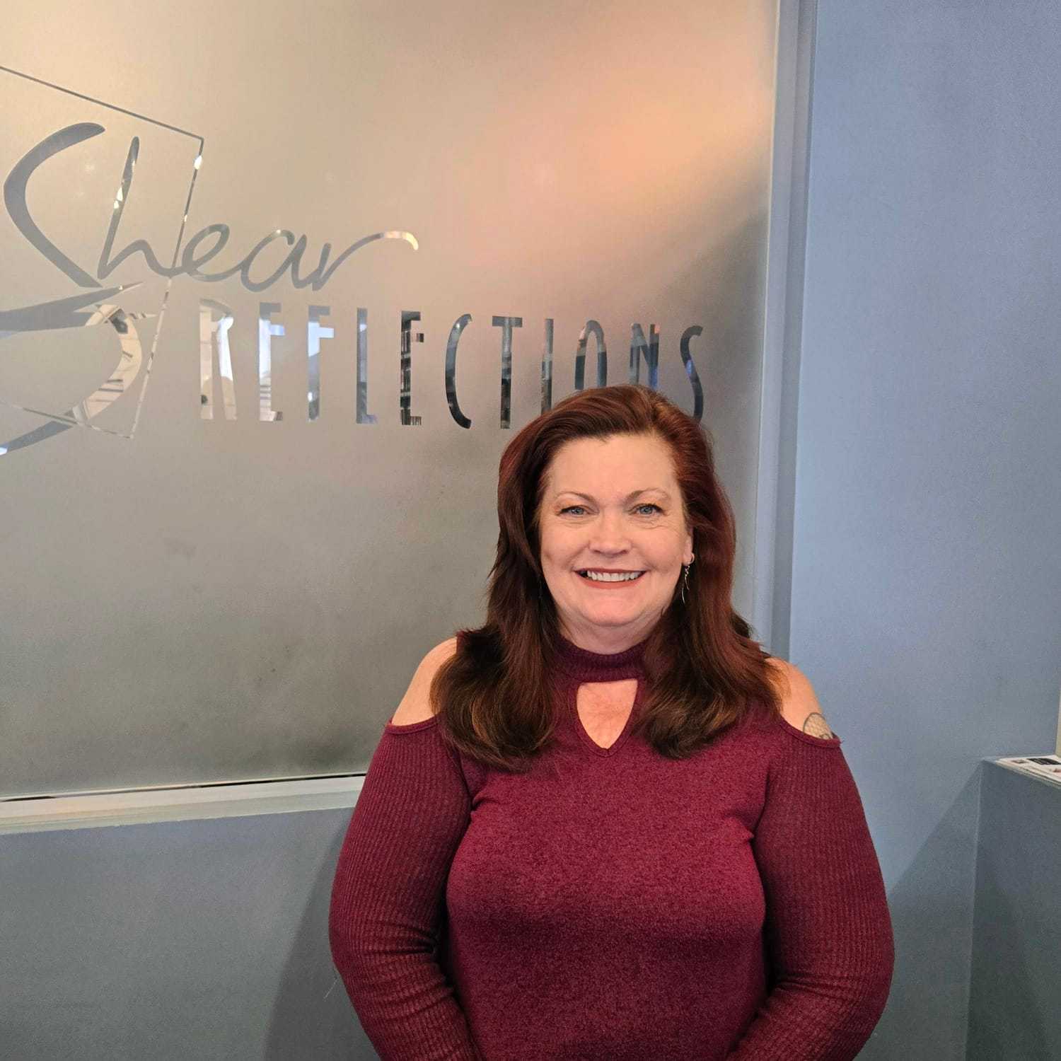 Portrait of Laura, a professional stylist at Shear Reflections Hair Salon, showcasing their expertise and style.