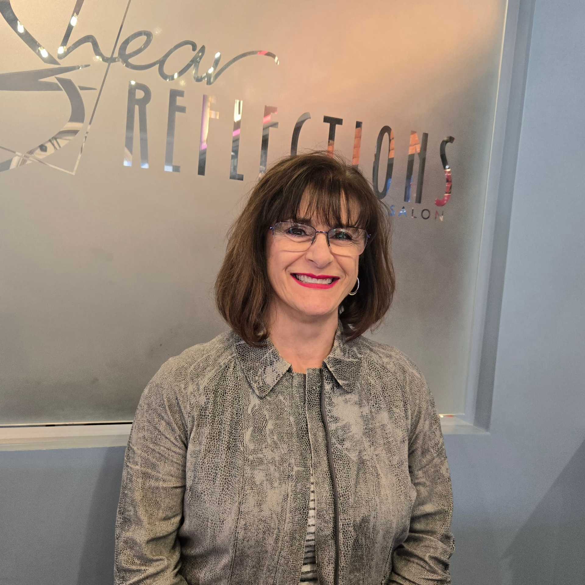 Portrait of Sue M., a professional stylist at Shear Reflections Hair Salon, showcasing their expertise and style.