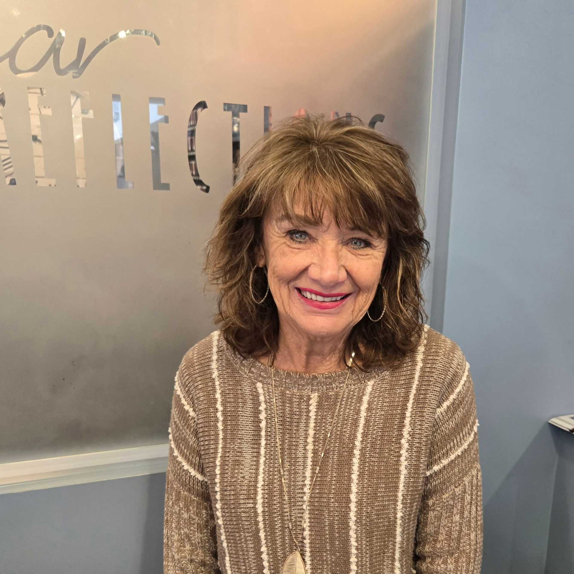 Portrait of Carol, a professional stylist at Shear Reflections Hair Salon, showcasing their expertise and style.